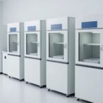 A row of environmental testing chambers along the lab wall with gray sample trays waiting in front