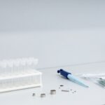 Bàn thí nghiệm phân tích nguyên tố với giá lọ mẫu, pipet, chi tiết kim loại nhỏ và mảnh bo mạch trong túi mẫu — ảnh bìa bài 10 chất bị hạn chế theo RoHS